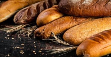 A variety of delicious bread including rye bread on the table which causes rye allergy,