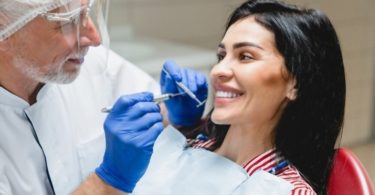 Beautiful caucasian woman getting ger teeth whitening treatment.