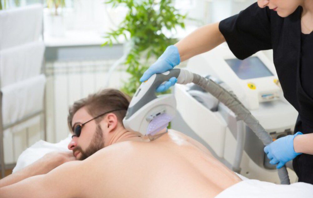 Young man getting laser back hair removal treatment at Milan laser hair removal.