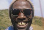 African man smiling with gaped buck teeth