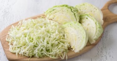 Cabbage Allergy - White cabbage chopped on wooden board.