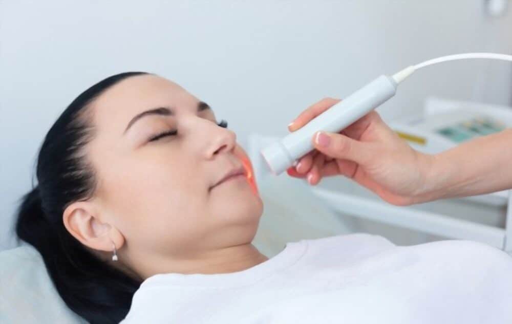 Woman getting Cold Sore Laser Treatment.