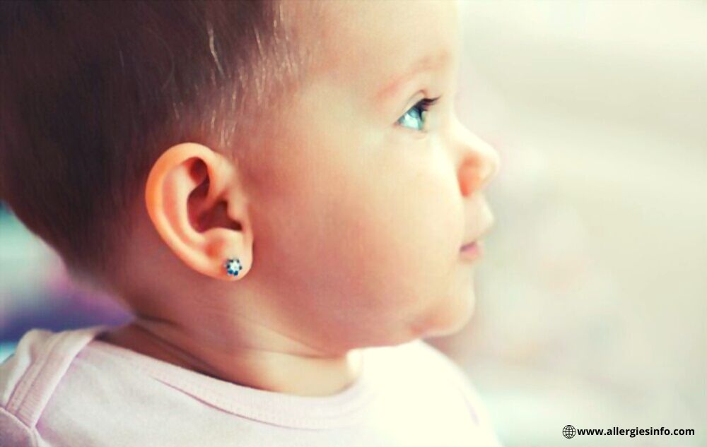 Ear piercing for kids - lovely baby with pierced ears