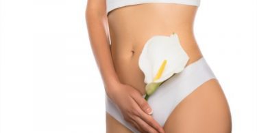 Concept of Vaginal Rejuvenation Laser Treatment - A girl with white flowers in hand