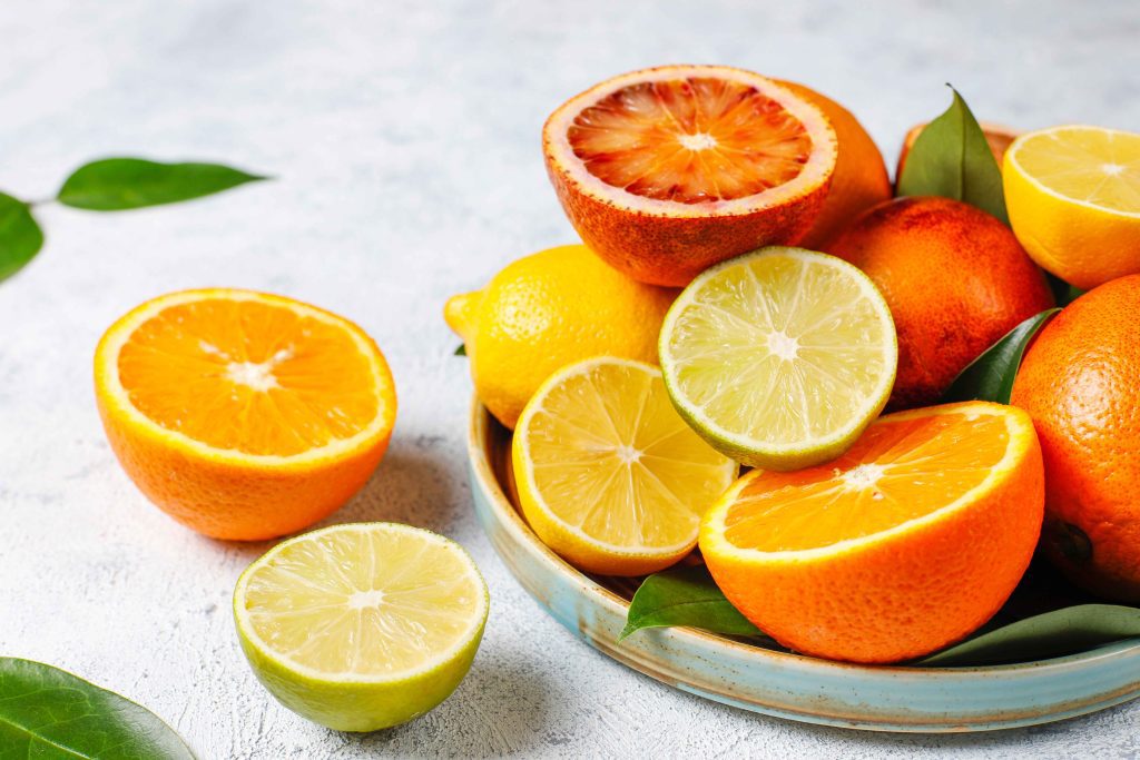 Citrus fruits are isolated on the table for the concept of citrus allergy.