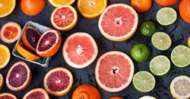 Different citrus fruits are isolated on the table for the concept of citrus allergy.