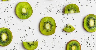 Slices of kiwi fruit isolated on the white background for the concept of Kiwi Allergy.